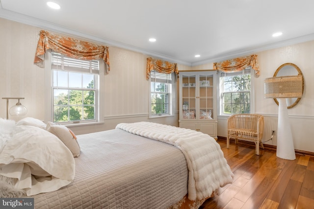 bedroom with crown molding and hardwood / wood-style flooring