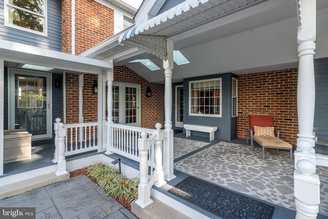 view of exterior entry featuring a porch