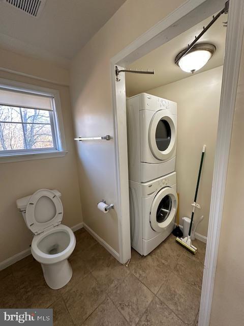 19 N Bridge St, Round Hill, VA 20141 - bathroom with estacked washer and dryer, baseboards, and toilet
