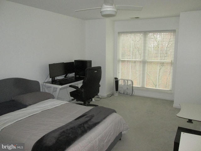 bedroom featuring light colored carpet and ceiling fan