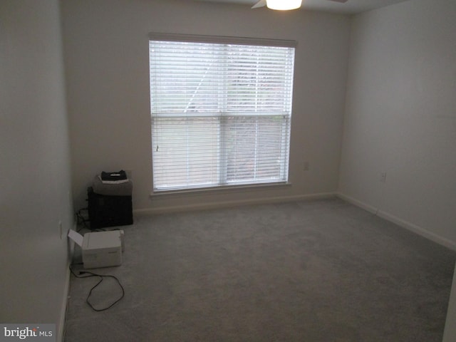 empty room with ceiling fan and carpet floors