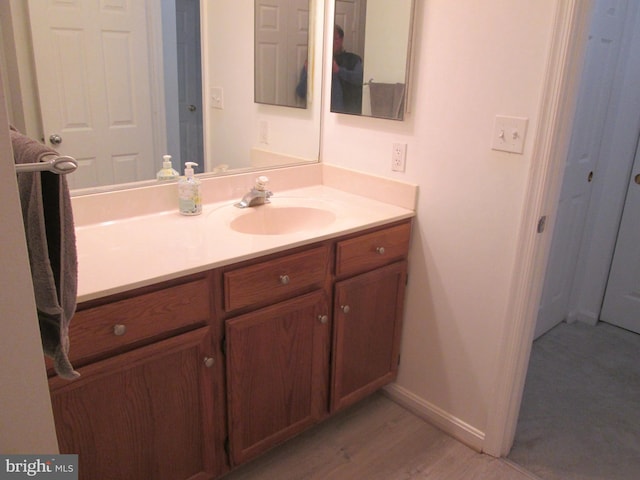 bathroom featuring hardwood / wood-style floors and vanity