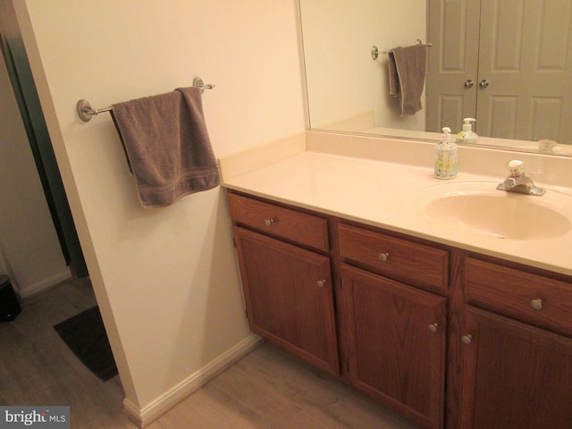 bathroom with hardwood / wood-style floors and vanity