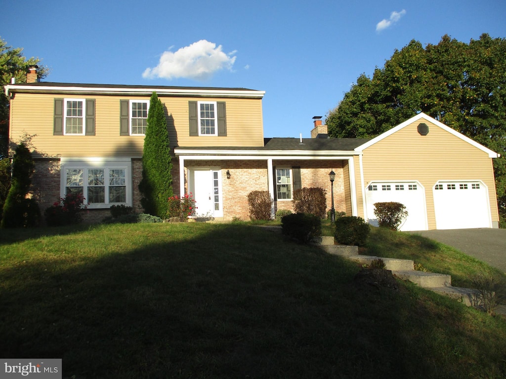 view of property with a front yard and a garage