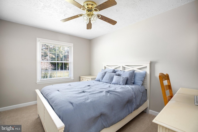 carpeted bedroom featuring a textured ceiling and ceiling fan