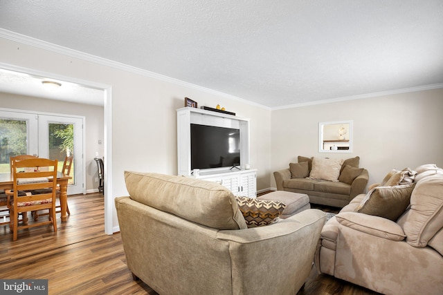 living room featuring hardwood / wood-style floors, crown molding, a textured ceiling, and french doors