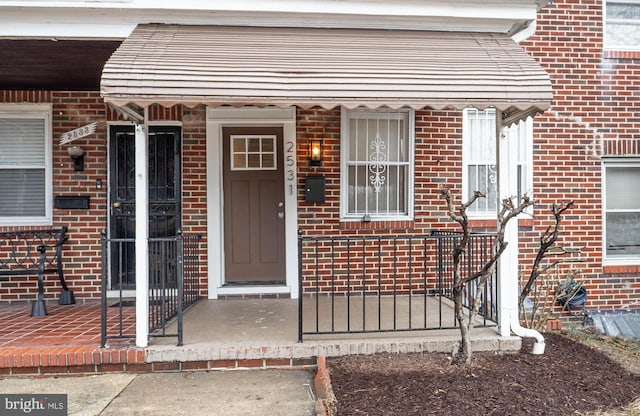 doorway to property featuring a porch