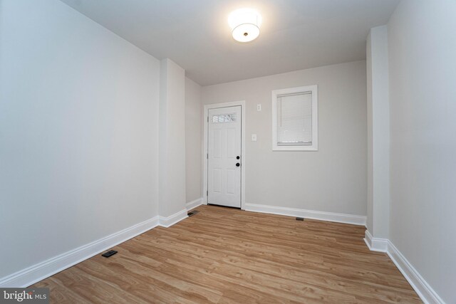 unfurnished room with light wood-type flooring