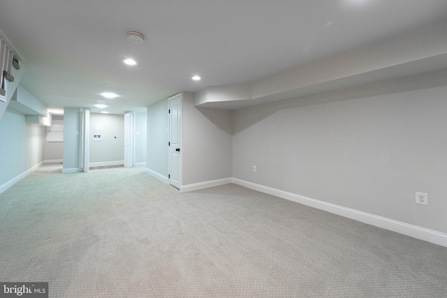 basement featuring light colored carpet