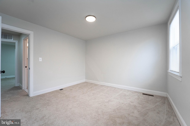 empty room featuring light carpet