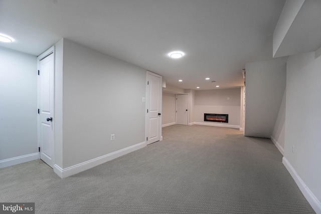 basement featuring light colored carpet