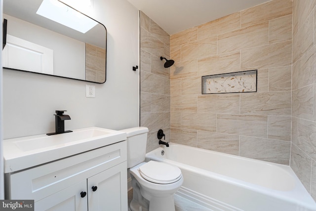 full bathroom featuring tiled shower / bath combo, vanity, and toilet