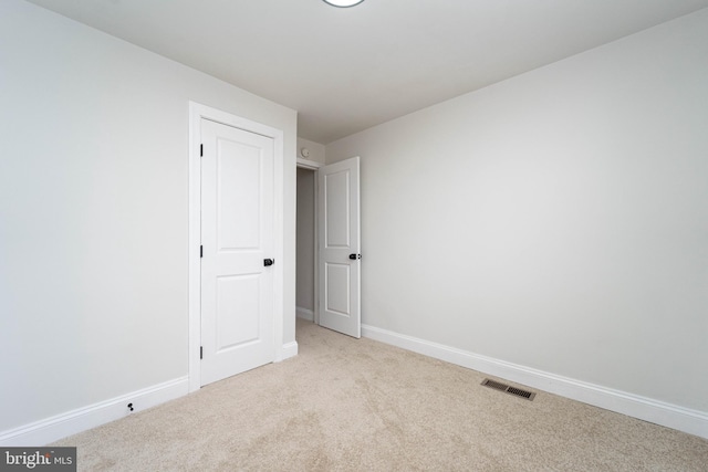 unfurnished room with light colored carpet