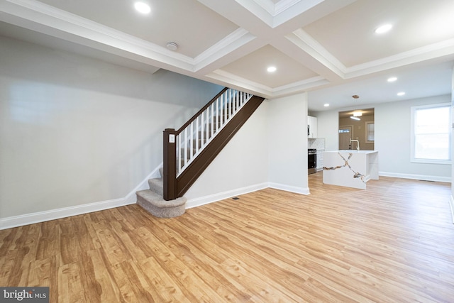 unfurnished living room with beam ceiling, coffered ceiling, sink, and light hardwood / wood-style floors