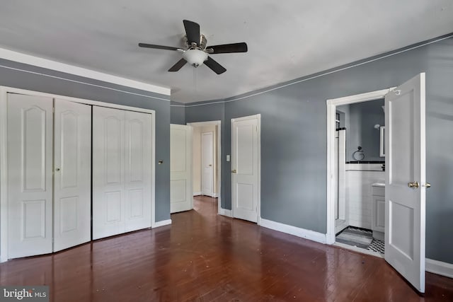 unfurnished bedroom with ensuite bath, ceiling fan, and dark hardwood / wood-style flooring