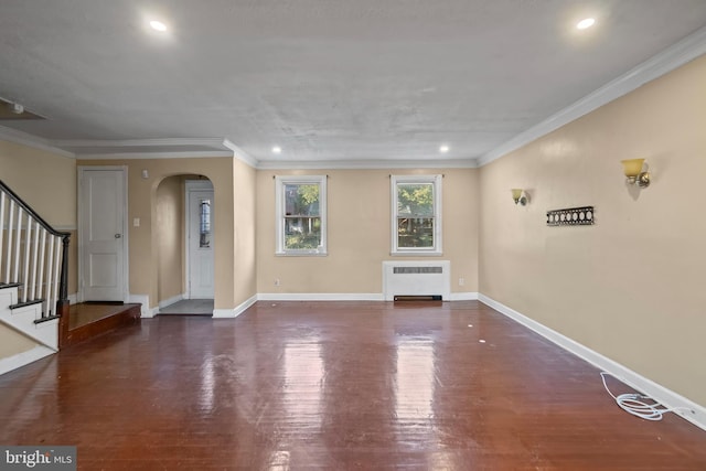 unfurnished living room with radiator heating unit, crown molding, and dark hardwood / wood-style flooring