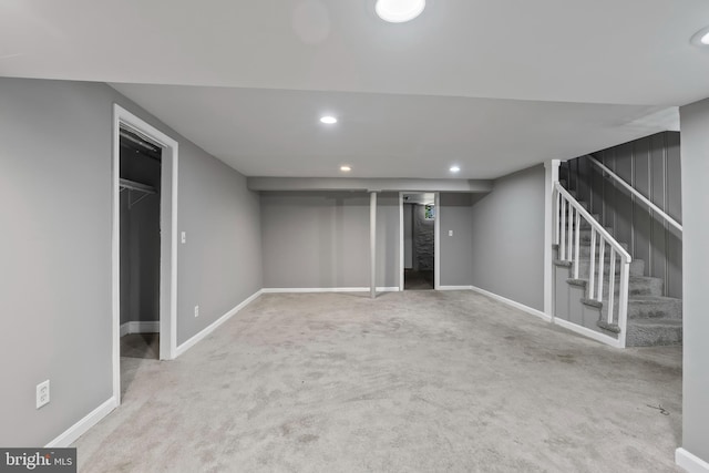 basement featuring light carpet