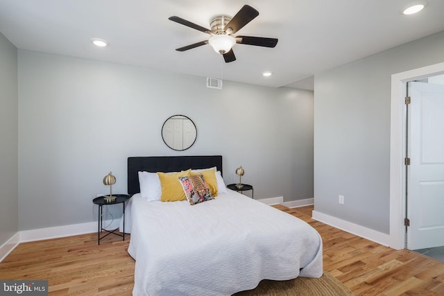 bedroom with light hardwood / wood-style flooring and ceiling fan