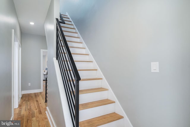 stairway featuring wood-type flooring