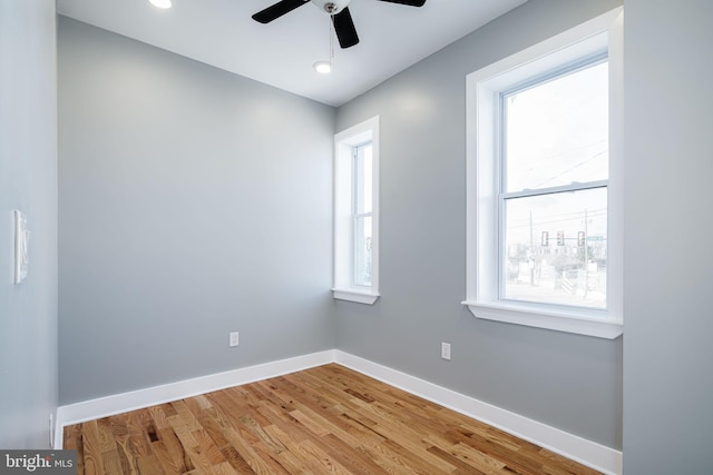 unfurnished room with light hardwood / wood-style flooring, ceiling fan, and plenty of natural light