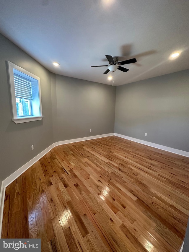 spare room with wood-type flooring and ceiling fan