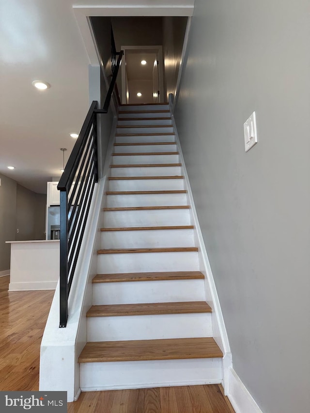 staircase featuring hardwood / wood-style floors