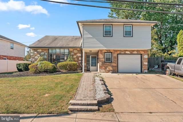 front facade featuring a garage and a front lawn