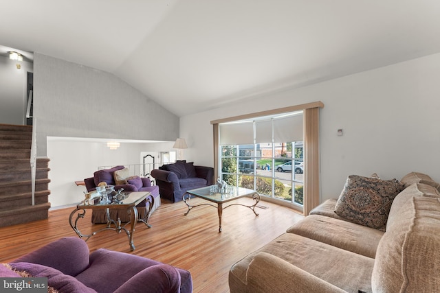 living room featuring lofted ceiling and hardwood / wood-style floors