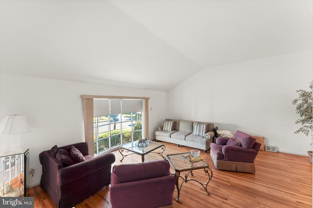 living room with hardwood / wood-style floors and vaulted ceiling