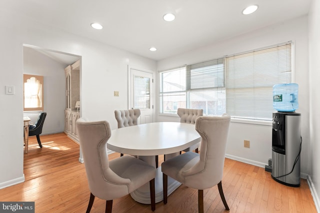 dining space with light hardwood / wood-style floors