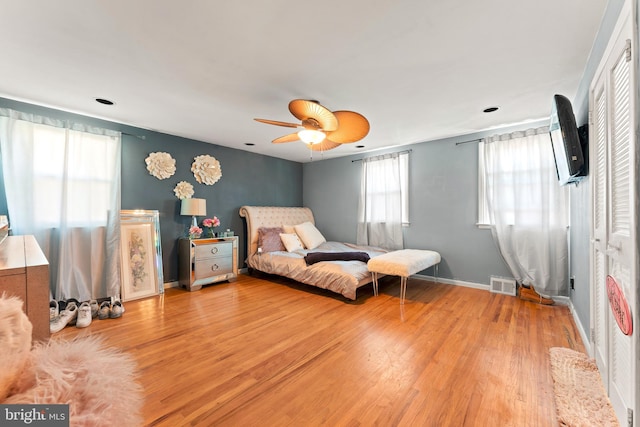 bedroom with ceiling fan and light hardwood / wood-style floors