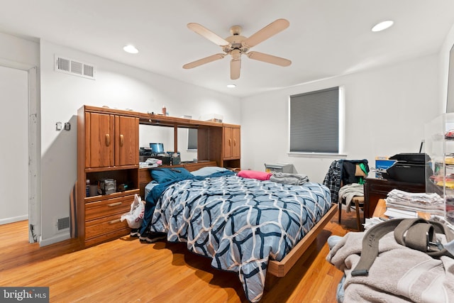 bedroom with ceiling fan and light hardwood / wood-style floors