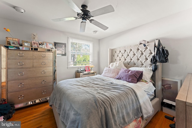 bedroom with ceiling fan and dark wood-type flooring