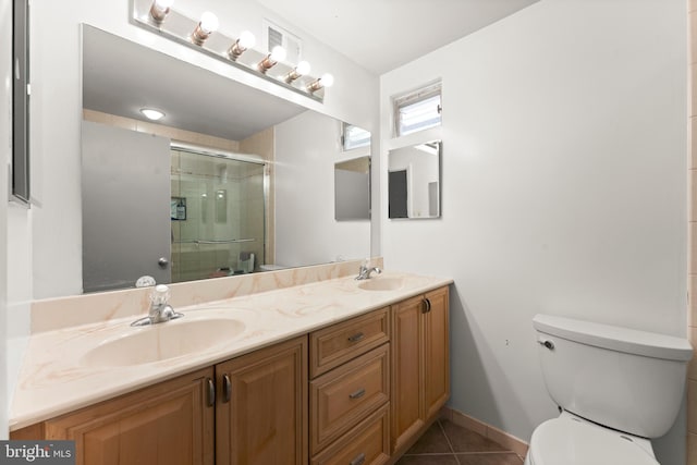 bathroom featuring walk in shower, vanity, toilet, and tile patterned floors