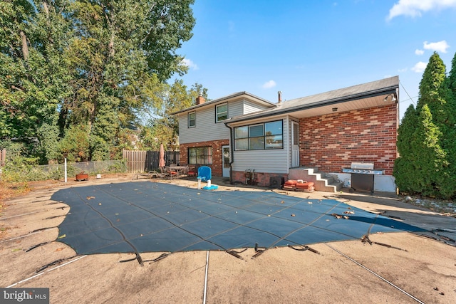 view of pool with a grill and a patio area