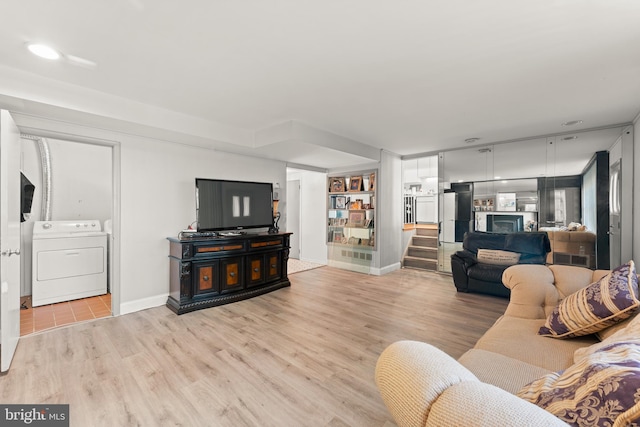 living room featuring washer / clothes dryer and light hardwood / wood-style floors