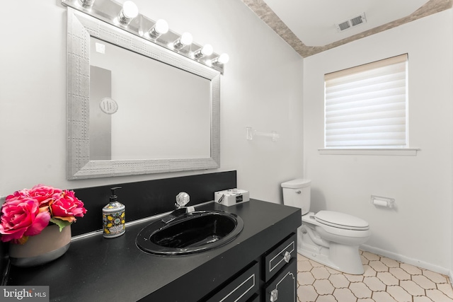 bathroom with toilet and vanity