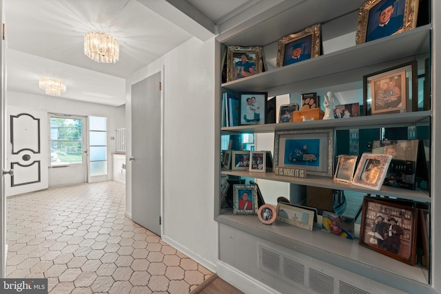 hallway featuring an inviting chandelier