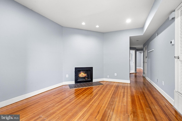 unfurnished living room featuring wood-type flooring