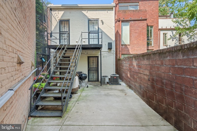 rear view of house featuring a patio area and central AC