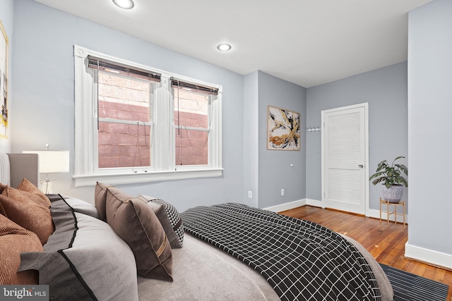 bedroom featuring wood-type flooring and a closet