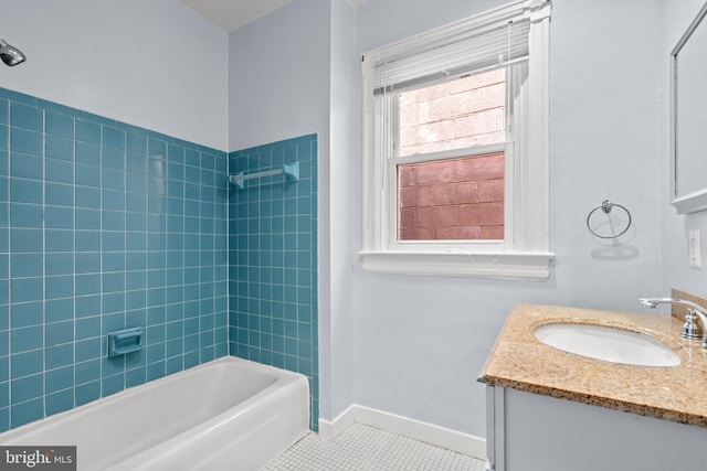 bathroom with vanity, tiled shower / bath combo, and tile patterned flooring