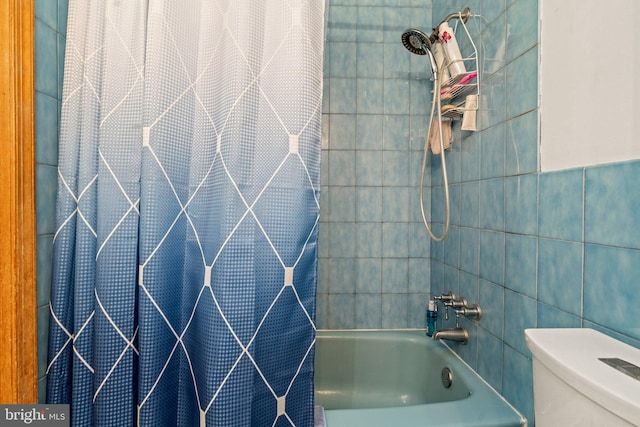 bathroom with shower / bath combination with curtain, toilet, and tile walls