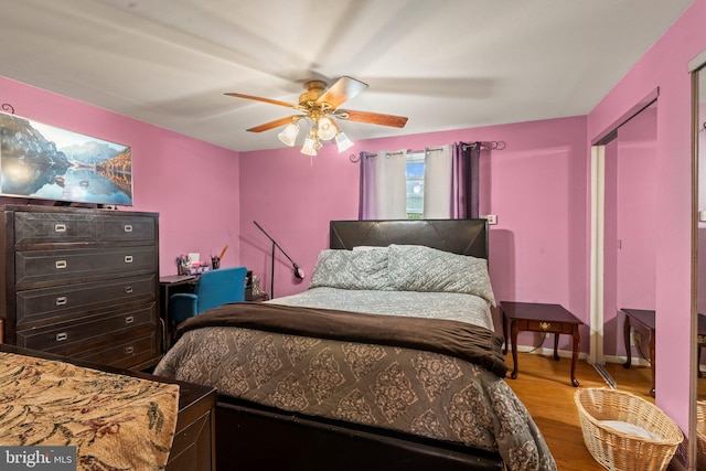 bedroom with hardwood / wood-style floors and ceiling fan