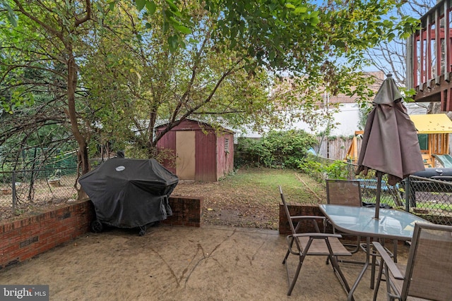 view of patio with a storage unit and area for grilling