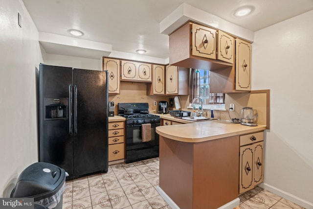 kitchen featuring light tile patterned floors, sink, kitchen peninsula, and black appliances