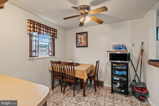 dining space with ceiling fan and light tile patterned floors