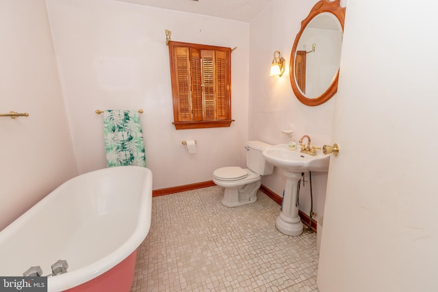 bathroom with a tub to relax in and toilet