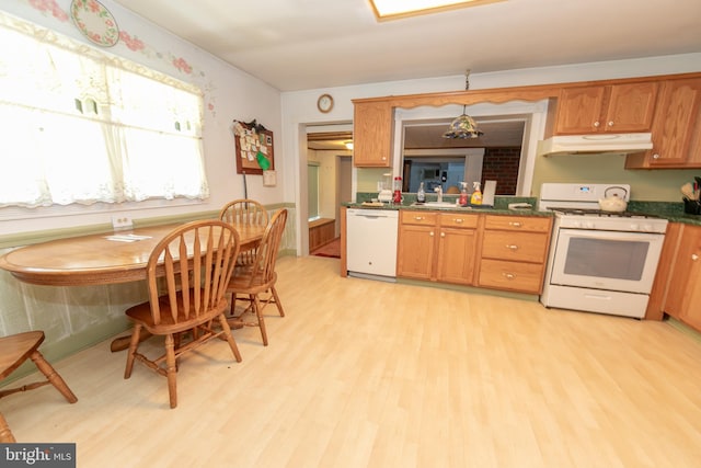 kitchen with white appliances and light hardwood / wood-style floors