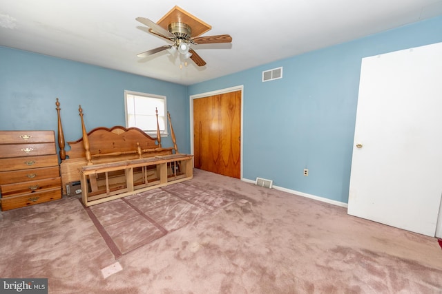 carpeted bedroom with ceiling fan and a closet